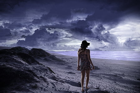 woman in black dress walking on sand thumbnail