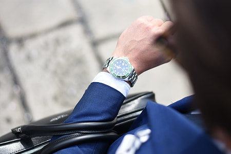 person looking at analog watch with 11:00 time thumbnail