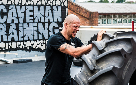 man pushing tire thumbnail