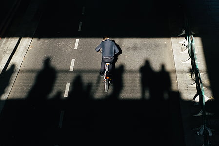 person riding bicycle on concrete road during daytime thumbnail