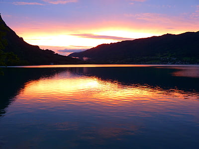 silhouette photo of sea and mountain thumbnail