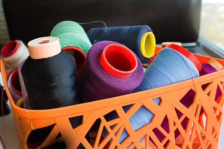 assorted thread rolls on basket thumbnail