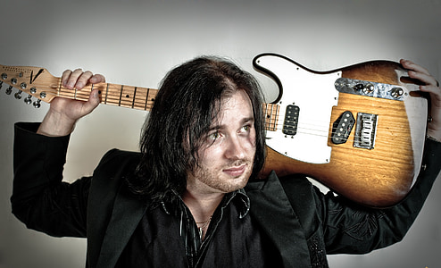 man carrying guitar thumbnail