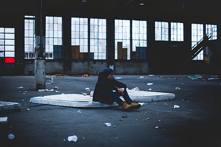 man sitting on white surface thumbnail