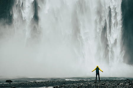man standing in front of waterfalls thumbnail
