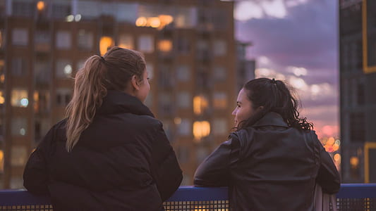 two person leaning on barrier thumbnail