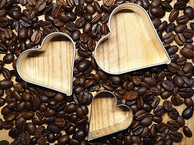 three heart-shaped cookie cutters surrounded by coffee beans thumbnail