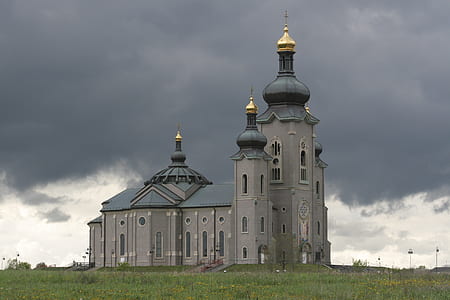 gray and blue concrete church under gray sky during daytime thumbnail