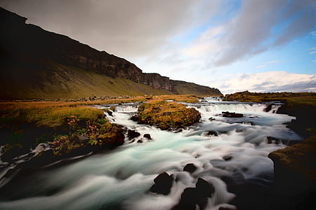 brown mountains beside river thumbnail