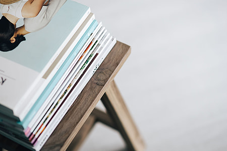 Stack of magazines on the wooden stool thumbnail
