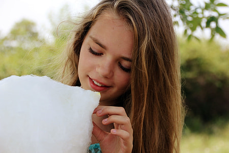 girl holding white cotton during datyime thumbnail