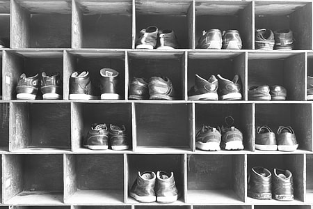 grayscale photo of pair of shoes on shoe boxes thumbnail
