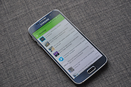 close up photo of black Samsung android smartphone on gray surface thumbnail