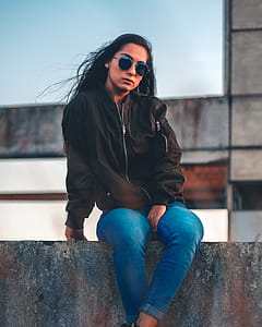 Photo of a Woman Sitting on a Ledge thumbnail