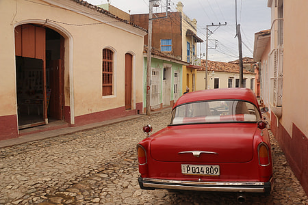 vintage red car parked on roadside thumbnail