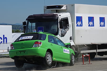 green Subaru Impreza 5-door hatchback crashed on white truck thumbnail