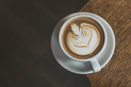 white ceramic cup and saucer with cafe latte thumbnail