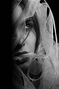 woman's face covered with white ribbon textile grayscale photography thumbnail