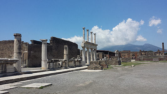 concrete buildings under blue sky and white clouds thumbnail