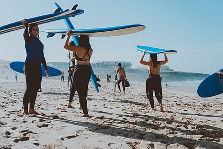 Photo of People Carrying Surfboards thumbnail