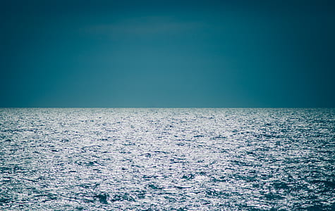Body of Water Under Clear Blue Sky thumbnail