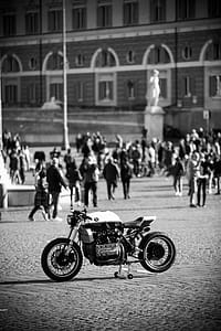 Grayscale Photo of Sports Bike Parked Near People thumbnail