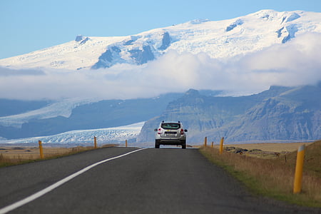 silver SUV running on gray road thumbnail