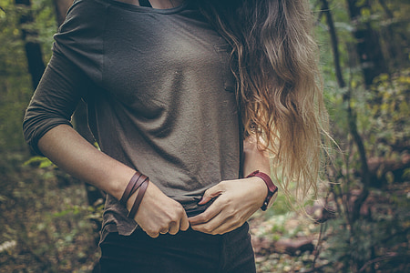 woman in black crew-neck mid-sleeved shirt holding her black bottoms thumbnail