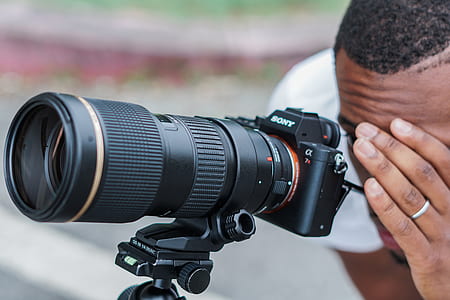 man taking photos using Sony DSLR camera thumbnail