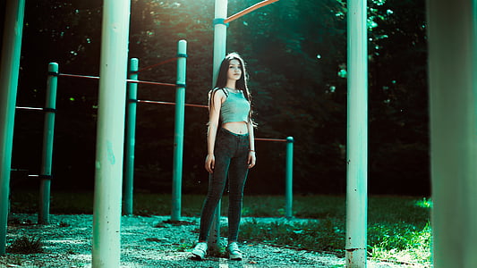 woman wearing teal crop top and black skinny jeans thumbnail