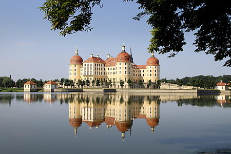 white and brown castle near body of water thumbnail