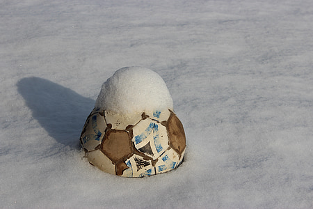 soccer ball buried on ground covered in snow thumbnail