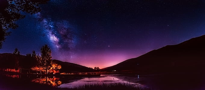 photo of body of water with trees during night time thumbnail