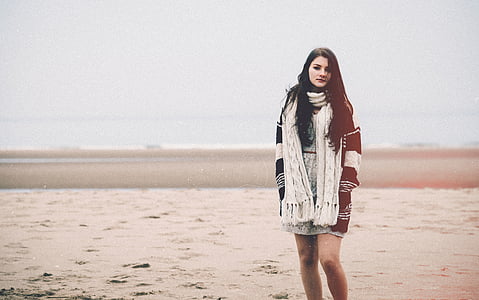woman wearing black and gray jacket standing on empty field at daytime thumbnail