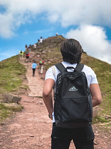 Man Carrying Black Addidas Backpack thumbnail