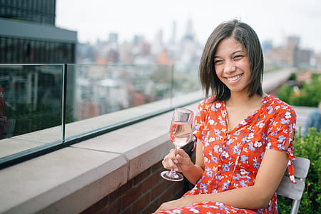Photo of a Woman Sitting on Chair Holding Wine Glass thumbnail