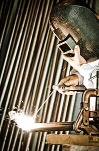 person wearing gray welding mask welding a steel bar thumbnail