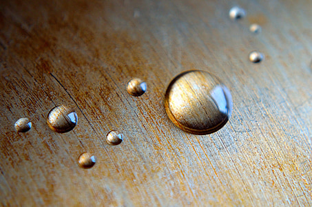 droplet of water on wooden surface thumbnail