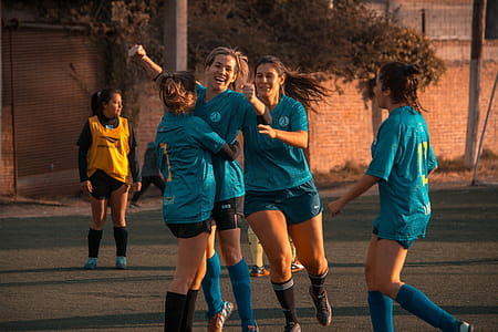 Four Women Embracing Each Other While Smiling thumbnail