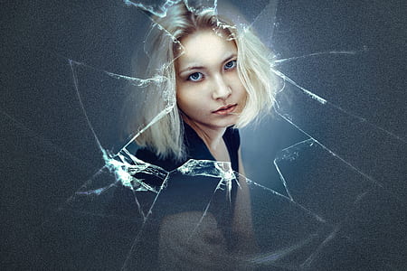 woman with platinum hair looking at broken glass thumbnail