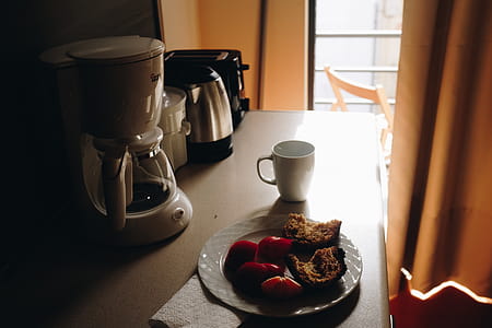 White Ceramic Mug Beside Ceramic Plate On Table thumbnail