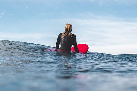 woman floating sitting on her surfboard thumbnail