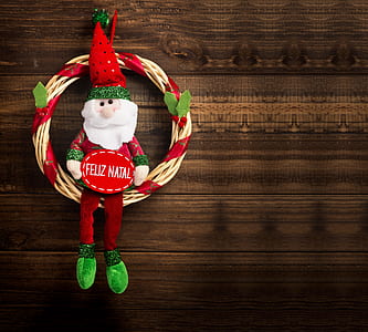 Santa Claus figurine on brown wooden surface thumbnail