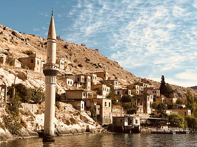brown concrete buildings beside bay thumbnail