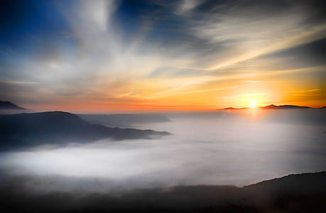 mountain and fog during golden hour thumbnail