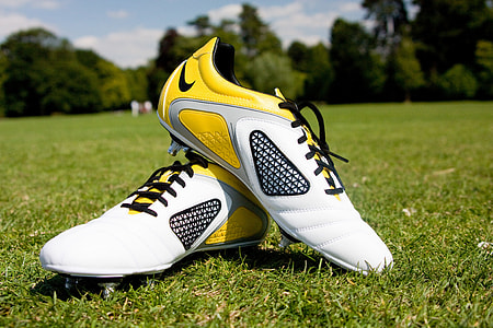 pair of white-yellow-and-black Nike cleats thumbnail