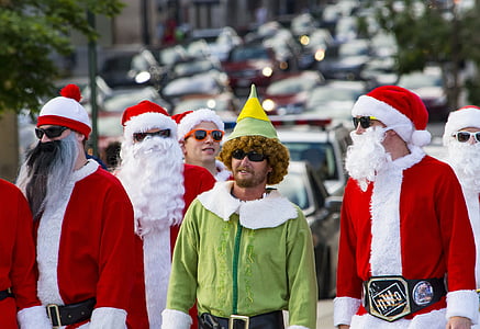 people wearing Santa Claus' and Elf costumes thumbnail