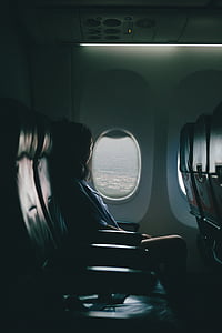 woman sitting inside airplane while looking outside thumbnail