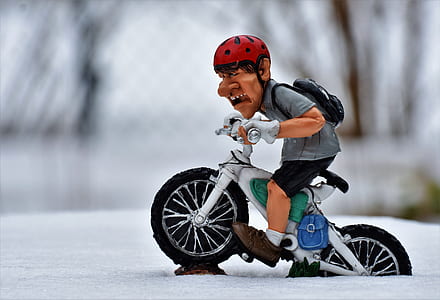 man riding on bicycle figurine thumbnail