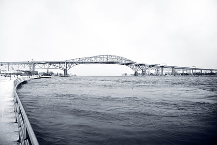body of water near metal bridge at daytime thumbnail